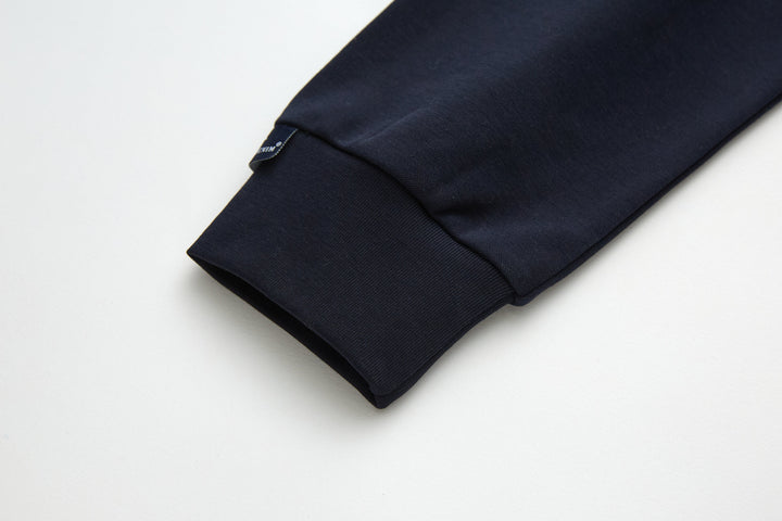 Navy top fabric close-up with visible stitching along side seam