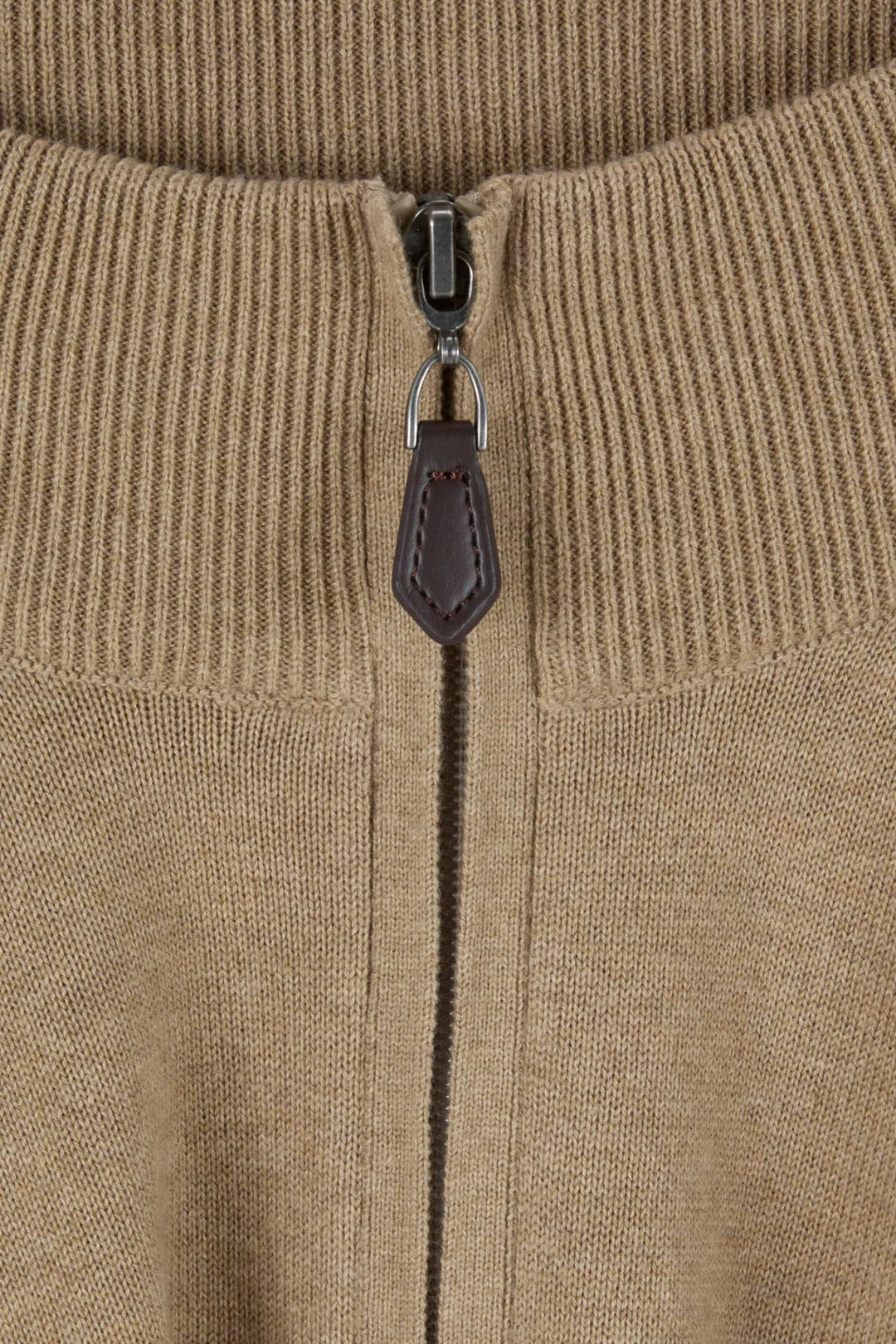 Beige knit 1/4-zip close-up with metal zipper and leather pull tab