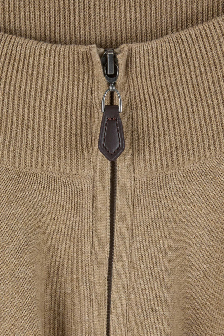 Beige knit 1/4-zip close-up with metal zipper and leather pull tab