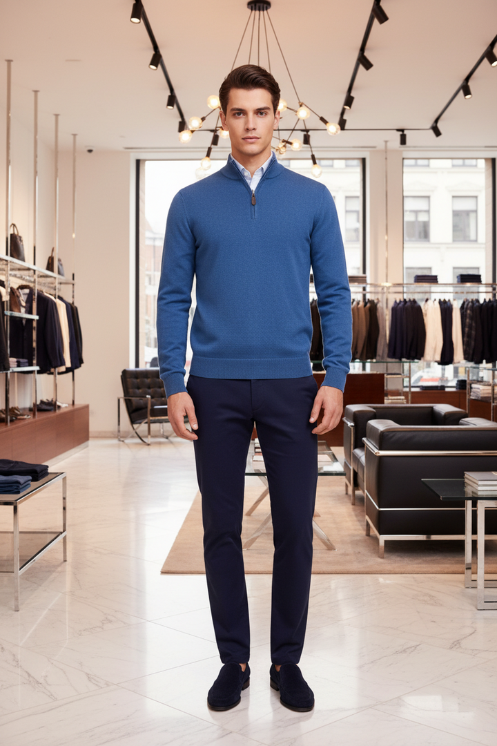 Blue 1/4-zip knit jumper with short zipper placket and ribbed collar, long sleeves.