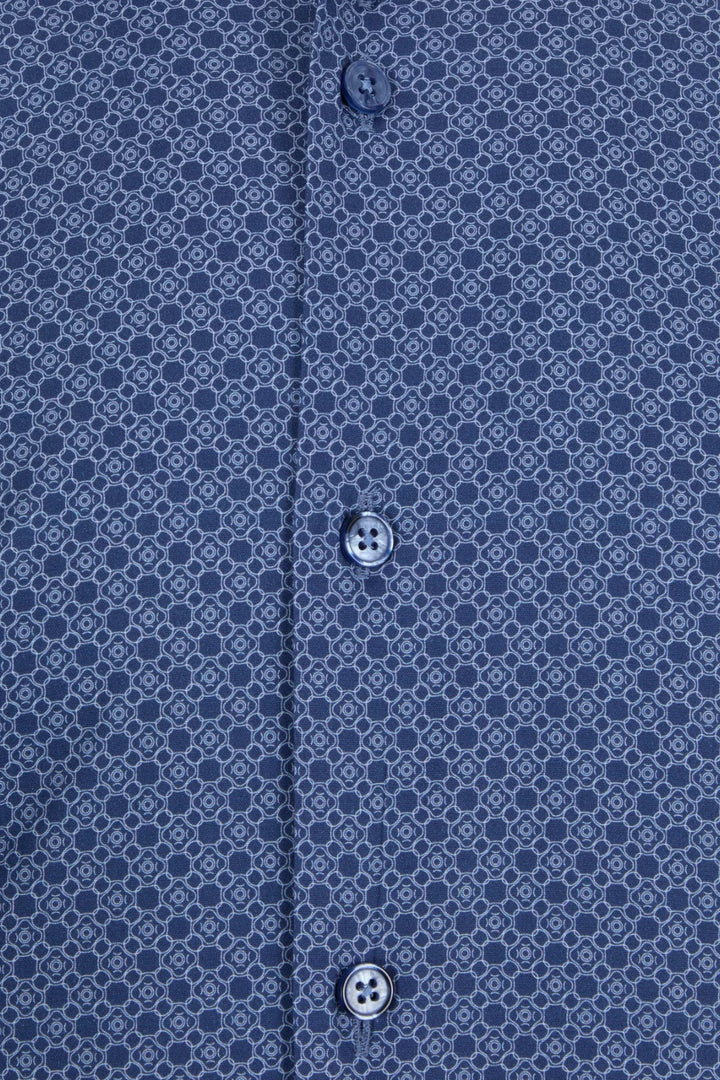 Dress shirt close-up: blue geometric print with black buttons.