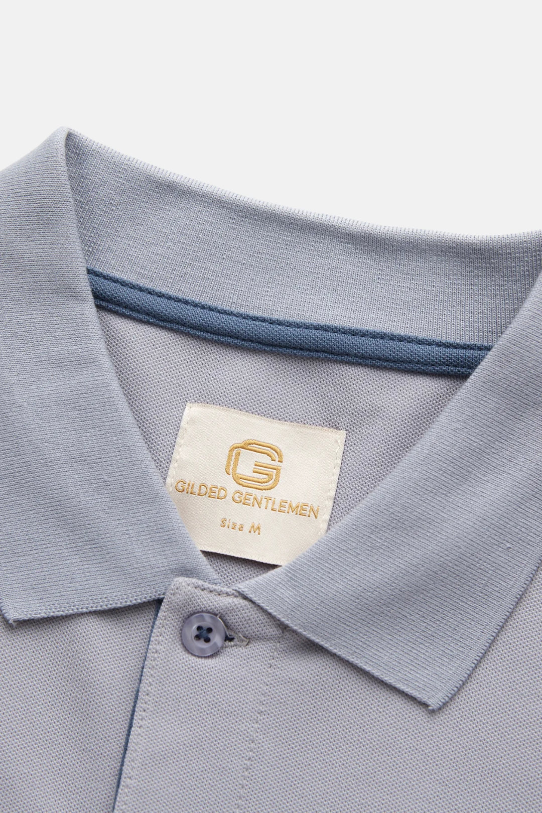 Grey polo shirt collar with stitched placket and Gilded Gentlemen label