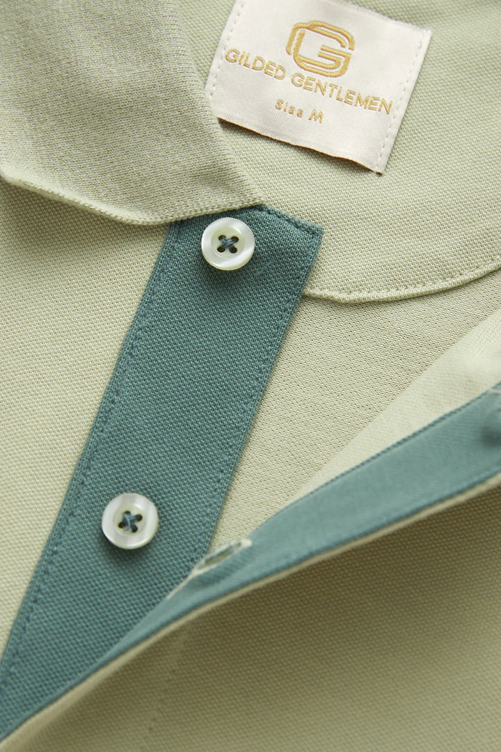 Light green polo shirt collar placket with blue inner tape and two buttons