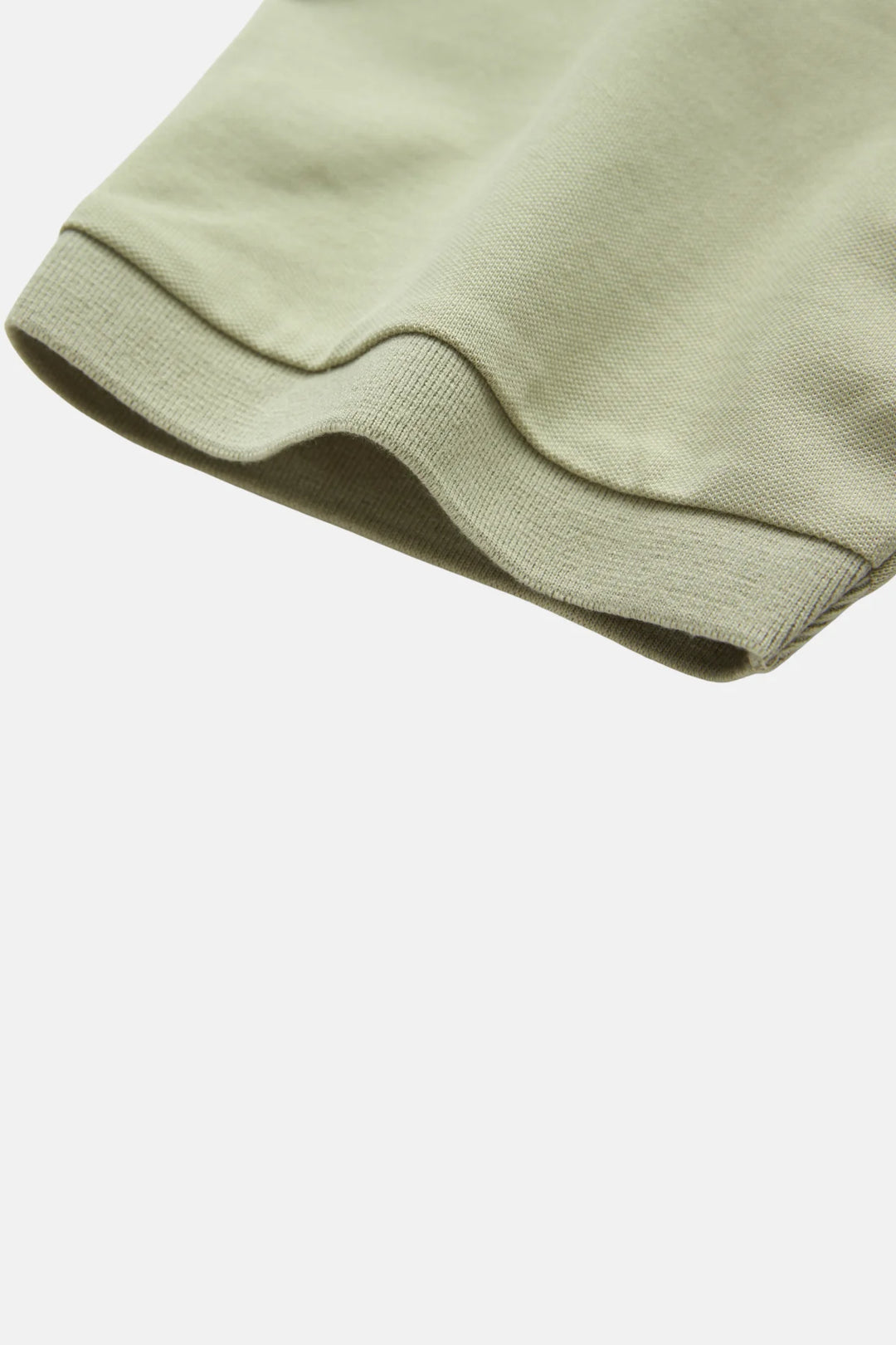 Light green polo shirt sleeve with ribbed cuff and stitched hem