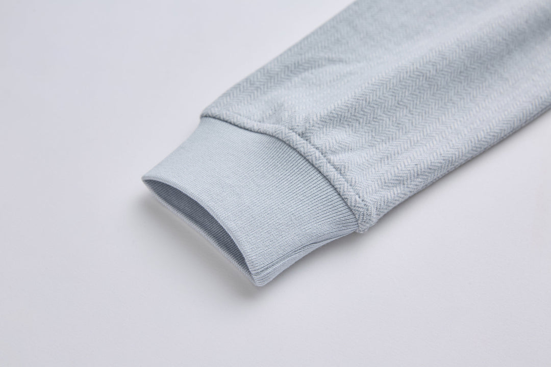 Grey herringbone 1/4-zip top sleeve cuff with elastic hem