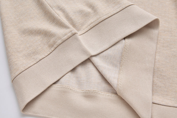 Ribbed hem and cuff detail on mushroom-beige 1/4-zip top