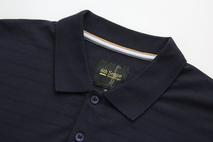 Dark navy polo shirt collar with branded neck label and button close-up