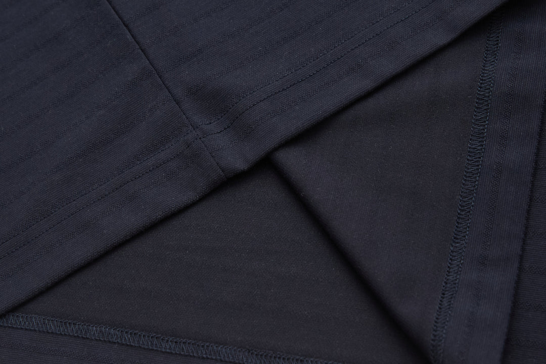 Dark navy polo shirt fabric with seams under placket detail