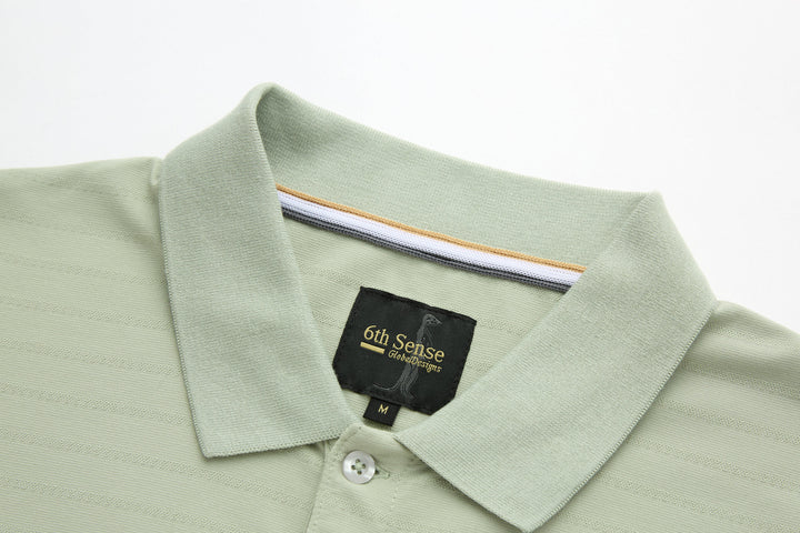 Sage polo shirt collar with 6th Sense neck label and button placket