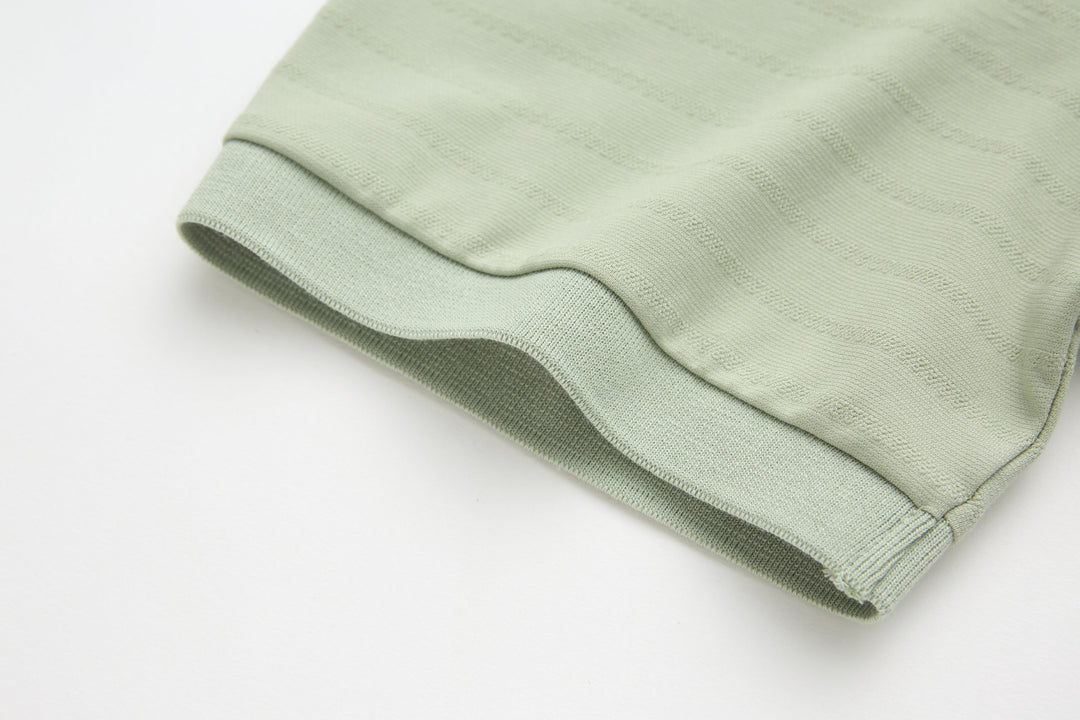 Sage polo shirt sleeve hem with clean stitched finish