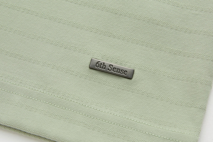 Sage polo shirt back hem with 6th Sense logo tab