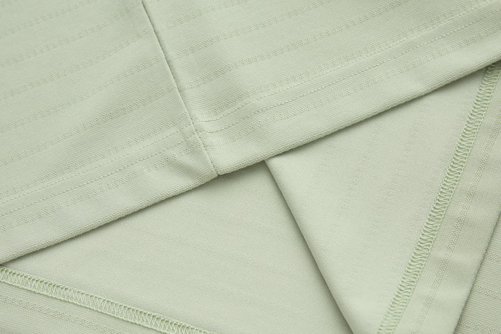 Sage polo shirt flat lay showing fabric weave and side seam