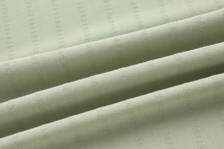 Sage polo shirt with textured fabric and stitched seam lines