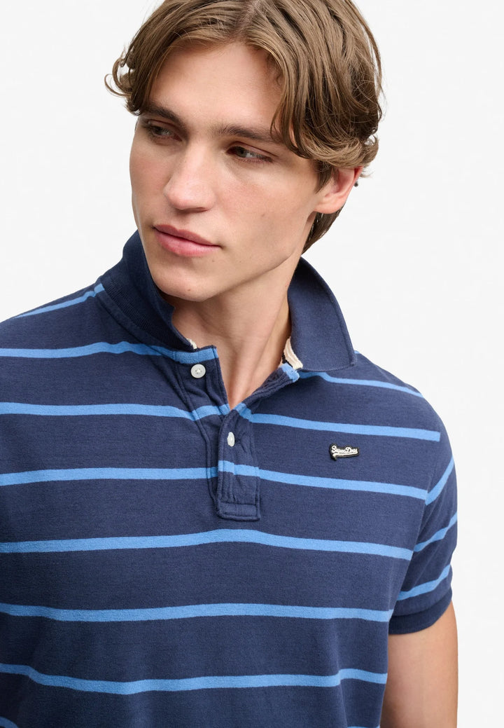 Close-up of navy blue striped polo shirt collar and button placket