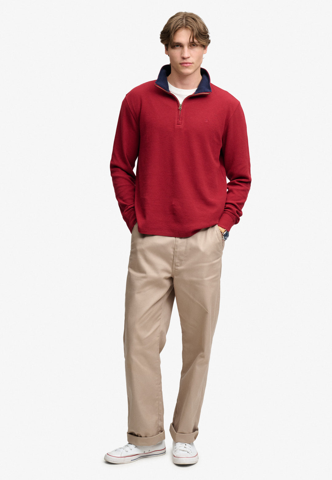 Men's burgundy half-zip sweater with navy collar trim and ribbed cuffs