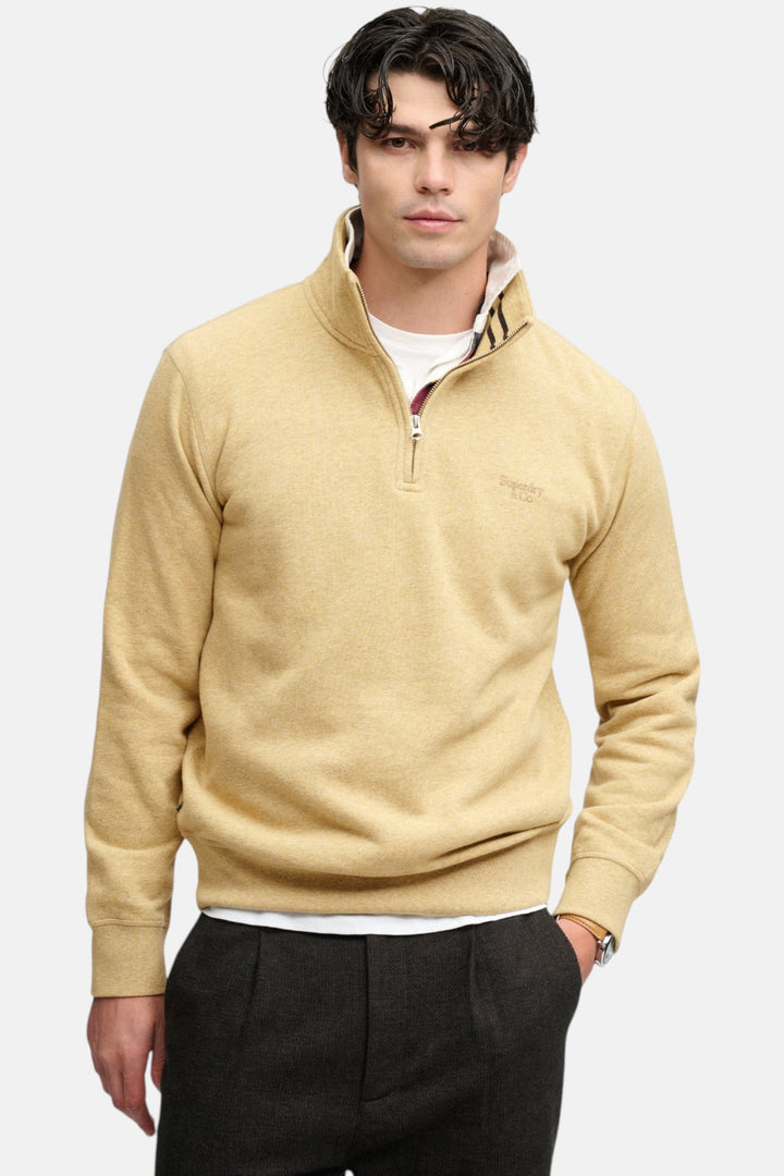 Men's tan half-zip sweater top with quarter zip pull and small chest logo
