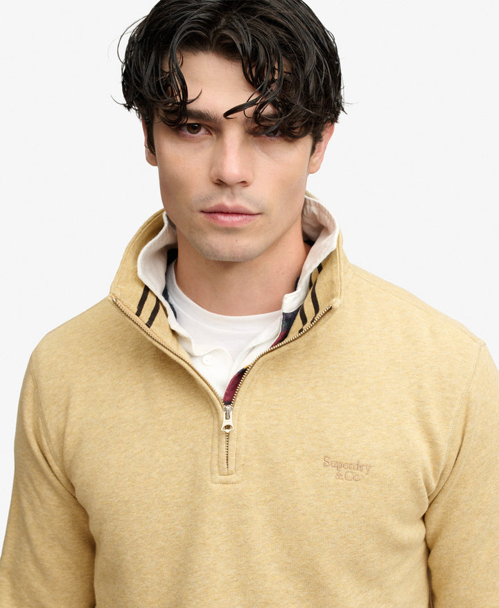 Men's tan half-zip sweater with striped inner neck facing and zip placket