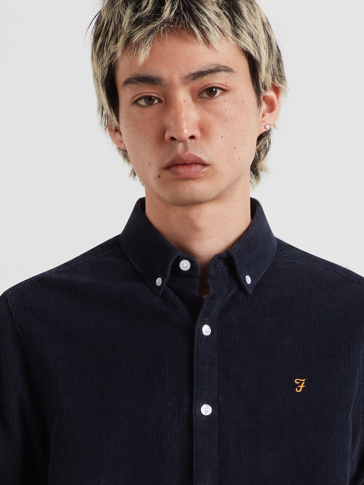 Navy long-sleeve button-front shirt with point collar and chest logo.