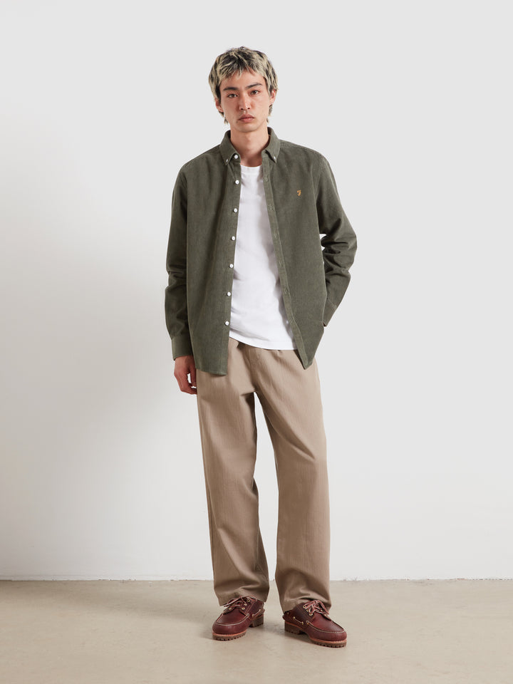 Long-sleeve button-down shirt in dark green corduroy, white button front