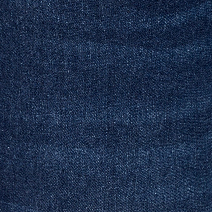 Blue jeans pocket with stitched seams and small logo patch on coin pocket