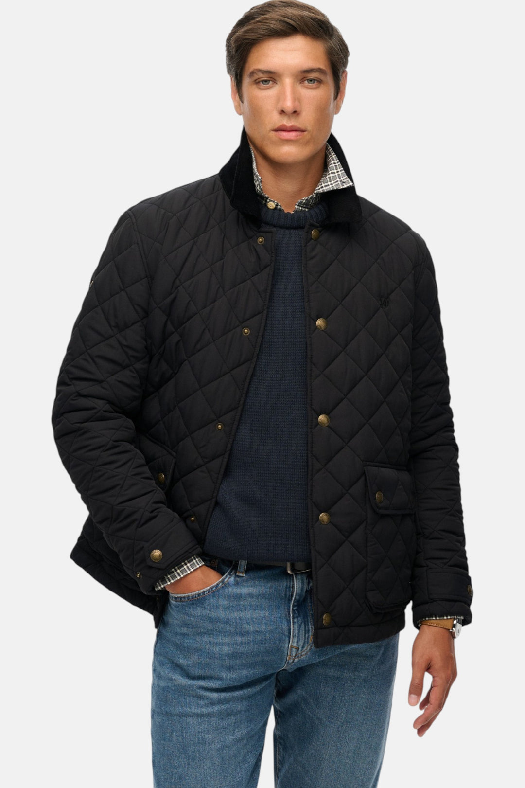 Quilted coach jacket in black with gold-tone buttons and snap pockets, stand collar.
