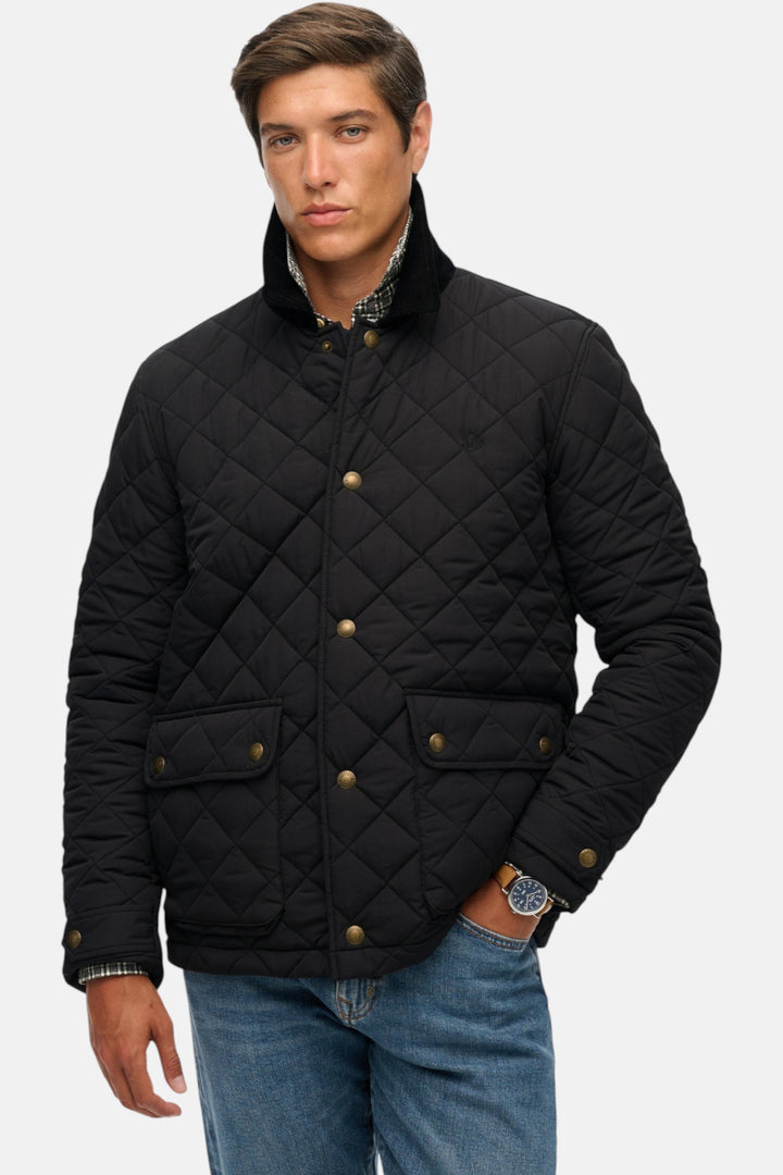 Quilted coach jacket in black, stand collar, gold buttons, two side snap pockets.