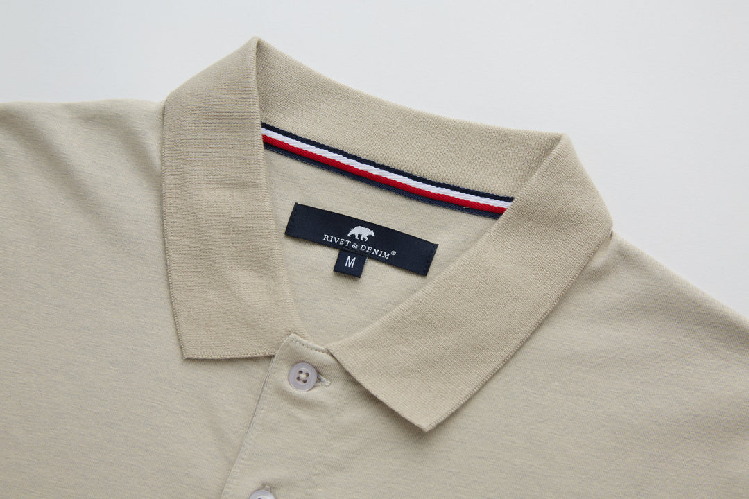 Beige polo shirt collar with interior red-white-blue trim and size label