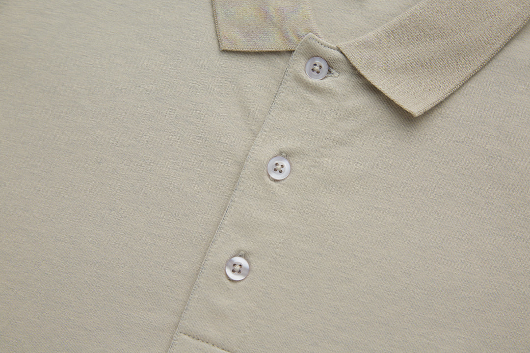 Beige polo shirt front with three white button placket and folded collar