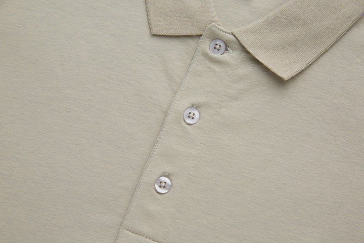 Beige polo shirt front with three white button placket and folded collar