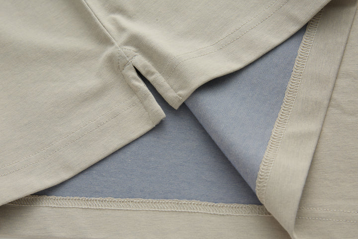 Beige polo shirt hem with visible seam and overlock stitching