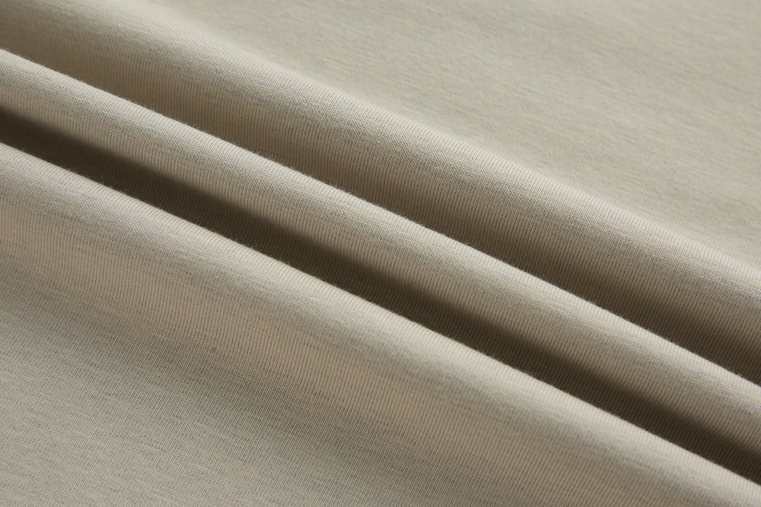 Beige polo shirt fabric close-up with fine knit texture