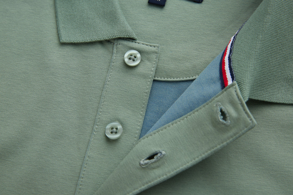 Mint polo shirt with open placket, buttons, and tricolor inside tape detail