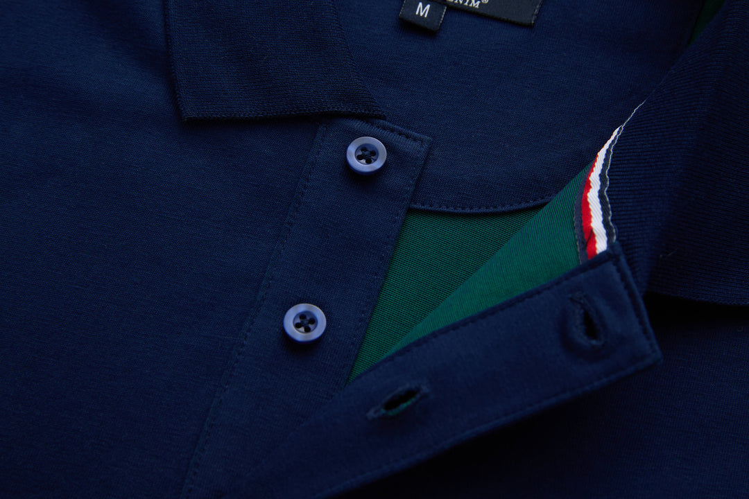 Navy polo shirt placket open to show green inner panel and tricolor trim