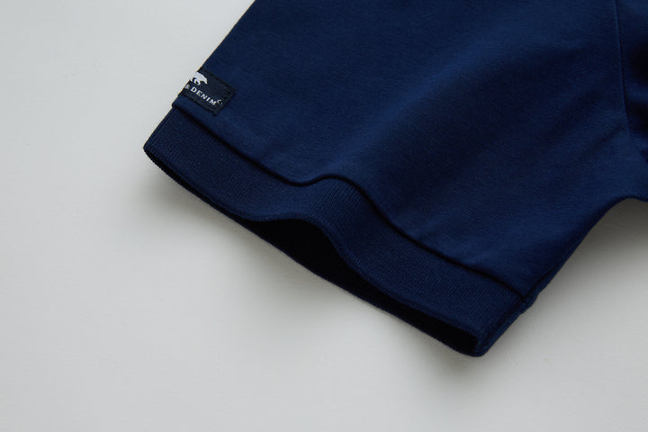 Navy polo shirt cuff and hem with small brand label