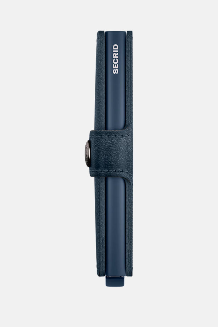 Navy miniwallet with vertical strap and circular snap detail