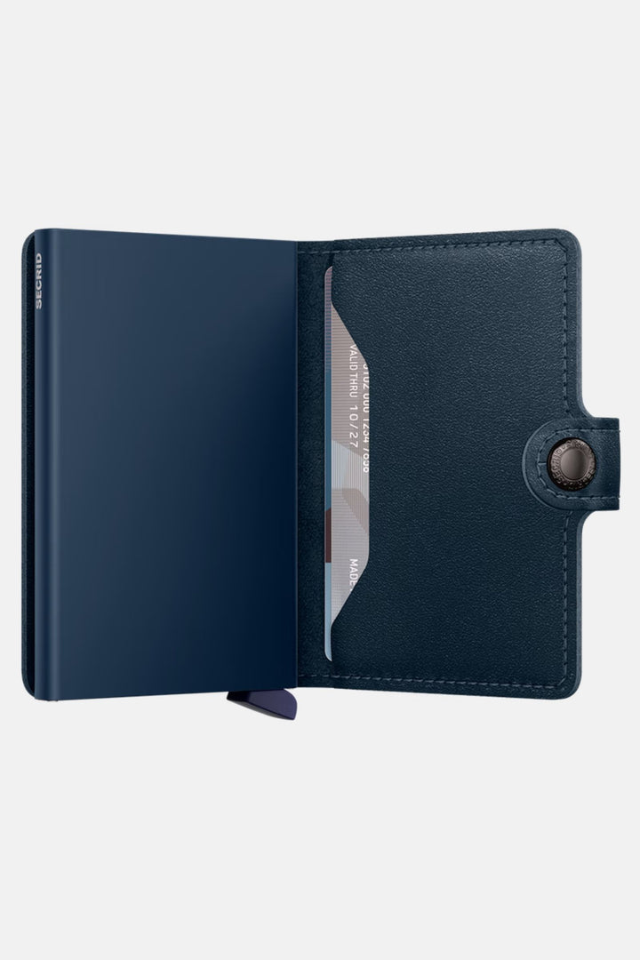 Navy miniwallet open, showing card slots and clear ID panel