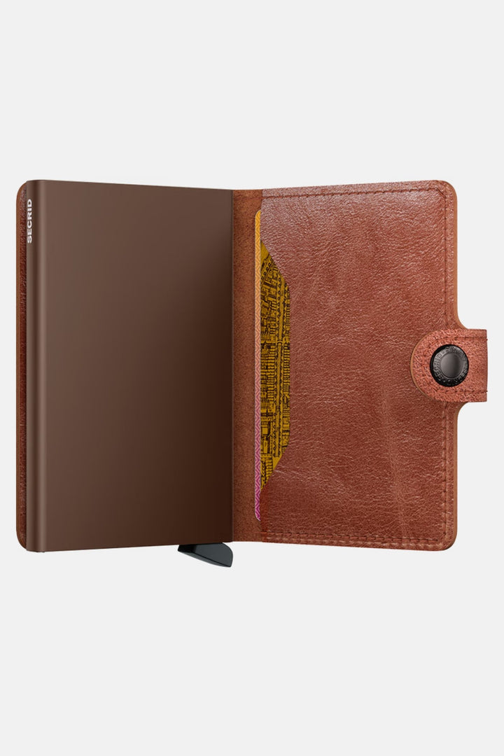 Secrid miniwallet open, vintage cognac-brown leather with card slots and metal button