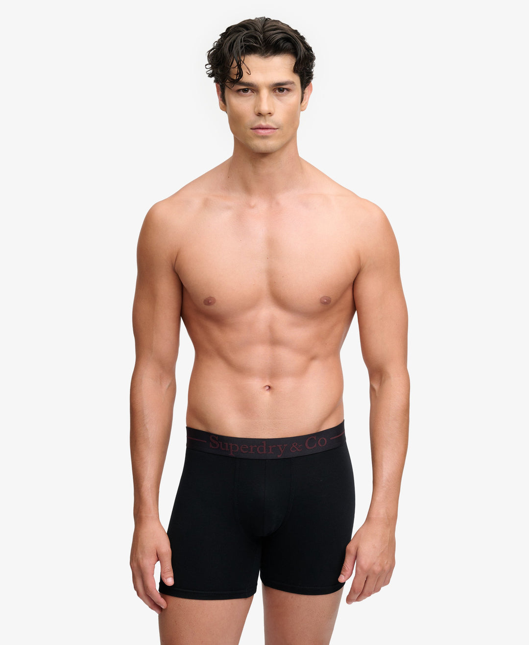 Black boxer briefs on model, short leg with logo waistband