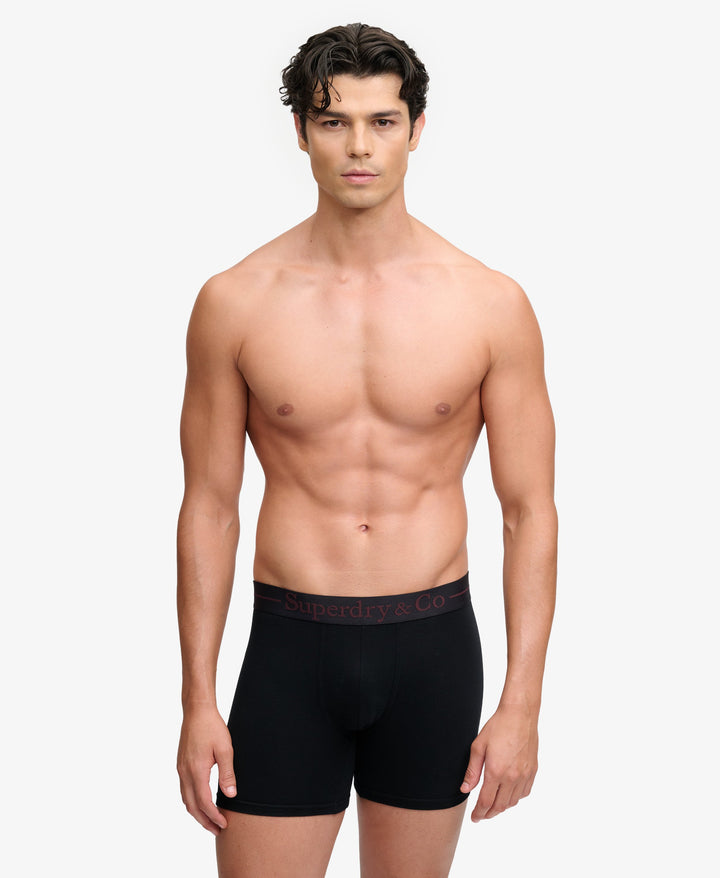 Black boxer briefs on model, short leg with logo waistband