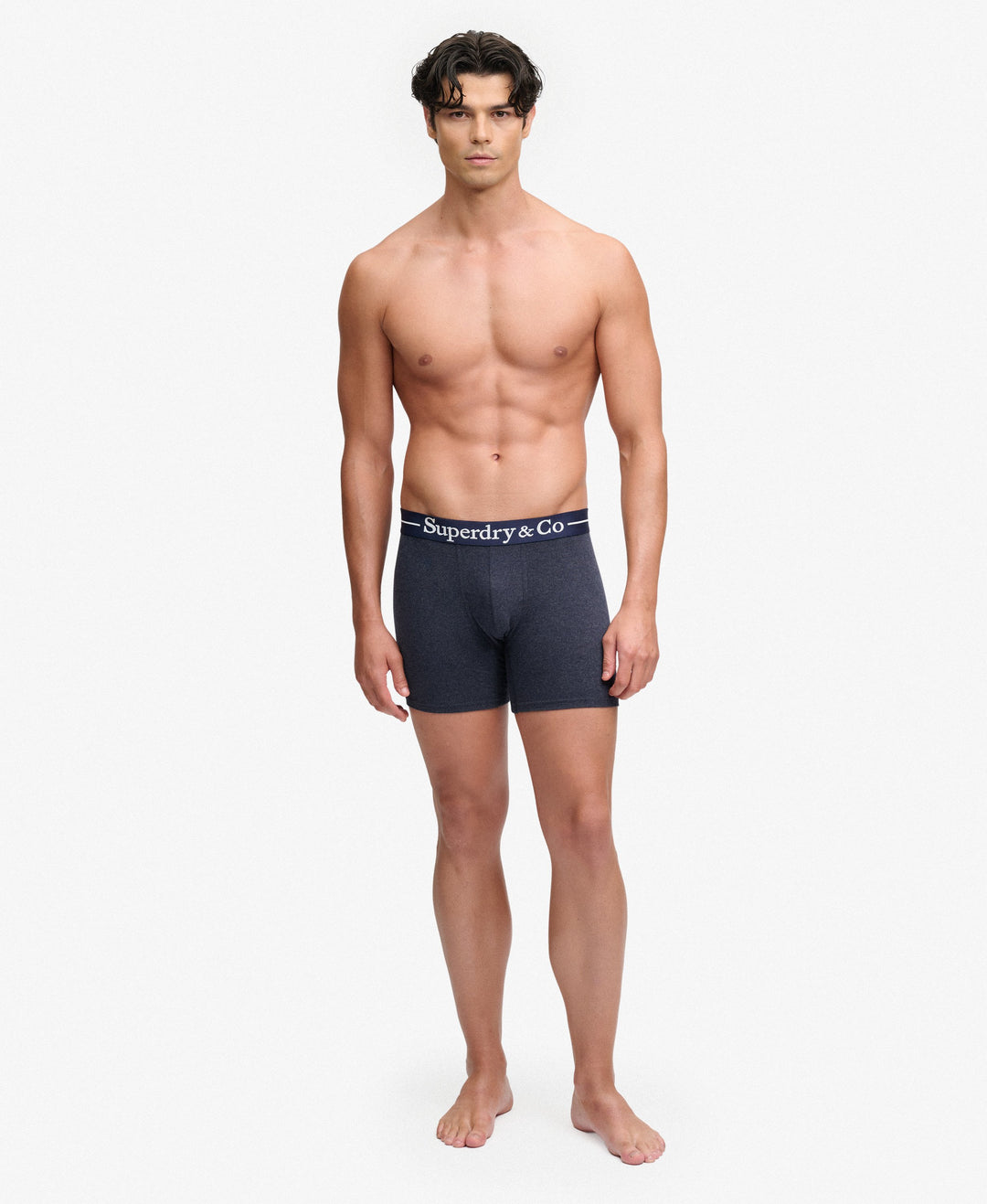 Men's navy marl boxer briefs on model, Superdry & Co logo waistband.