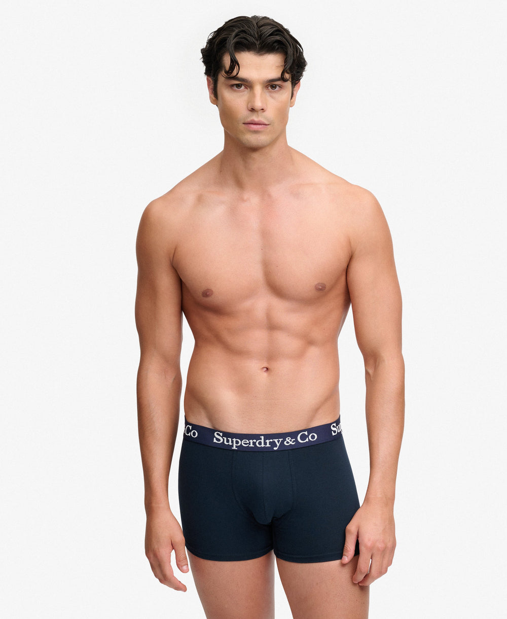 Men's navy boxer shorts on model, logo waistband, front view