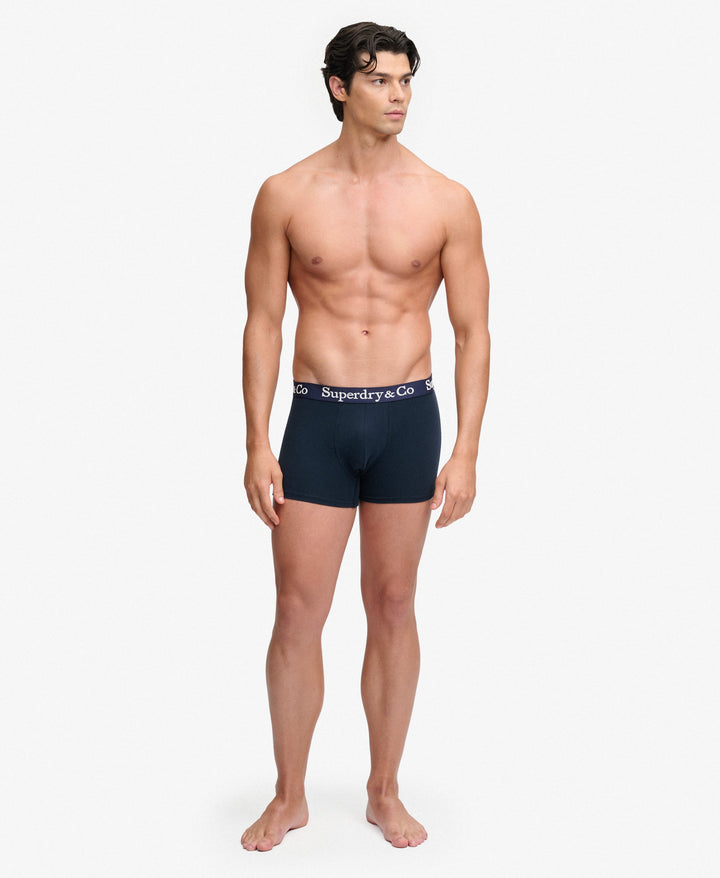 Men's navy boxer shorts on model, logo waistband, side view