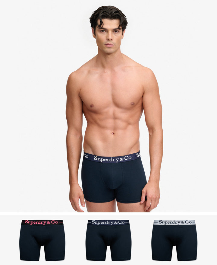 Men's navy boxer shorts on model, logo elastic waistband, front view