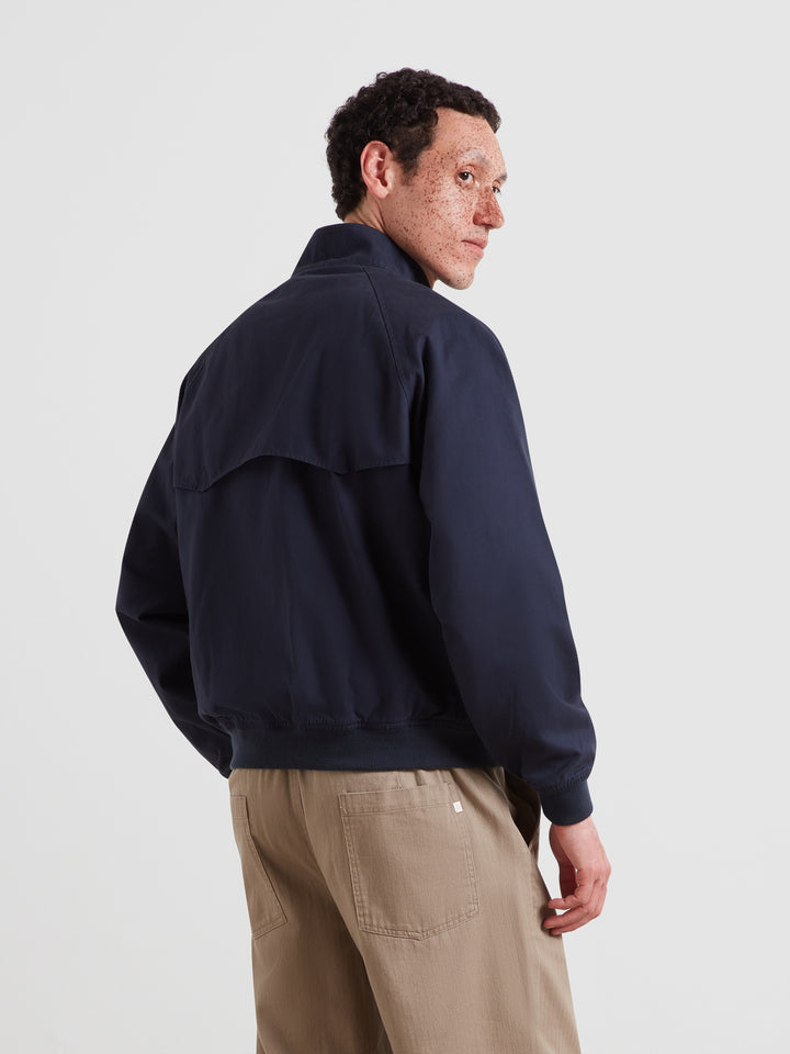 Navy Harrington jacket, side view with stand collar and full front zip