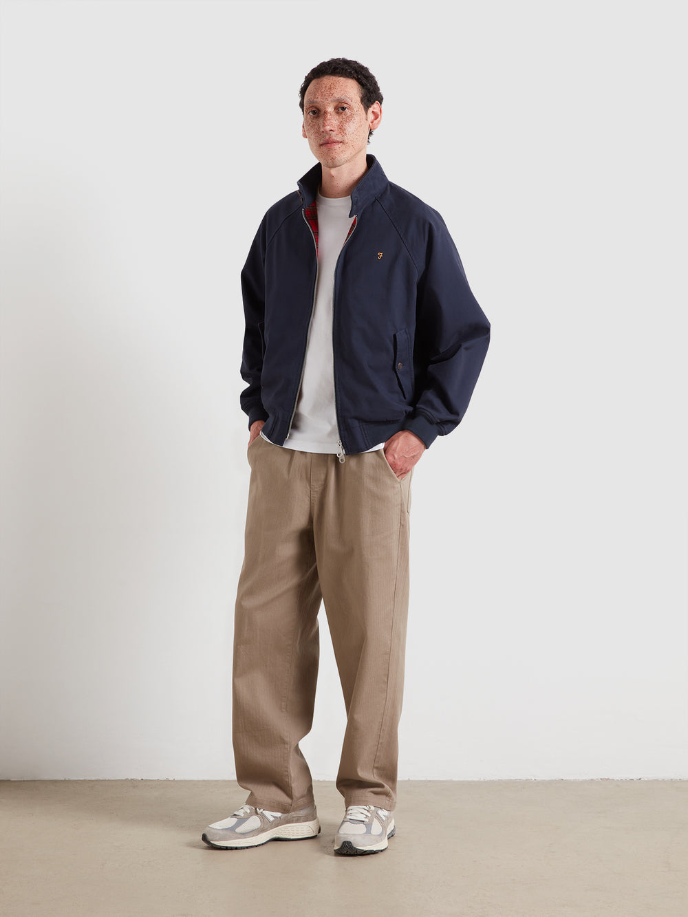 Navy Harrington jacket with full zip and stand collar, worn over white T-shirt