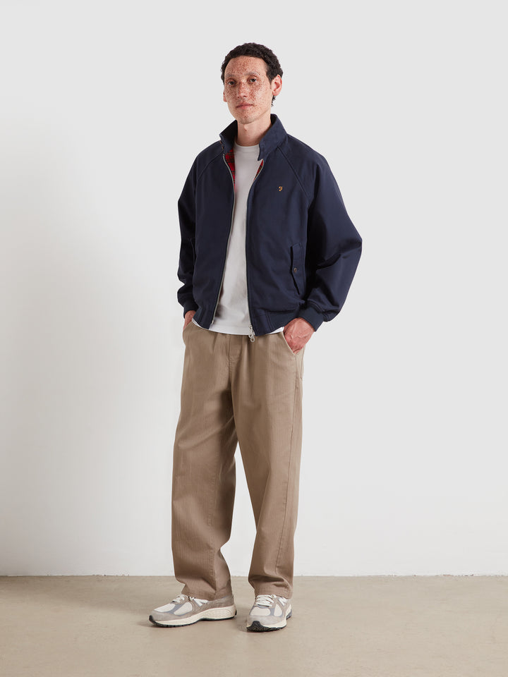Navy Harrington jacket with full zip and stand collar, worn over white T-shirt
