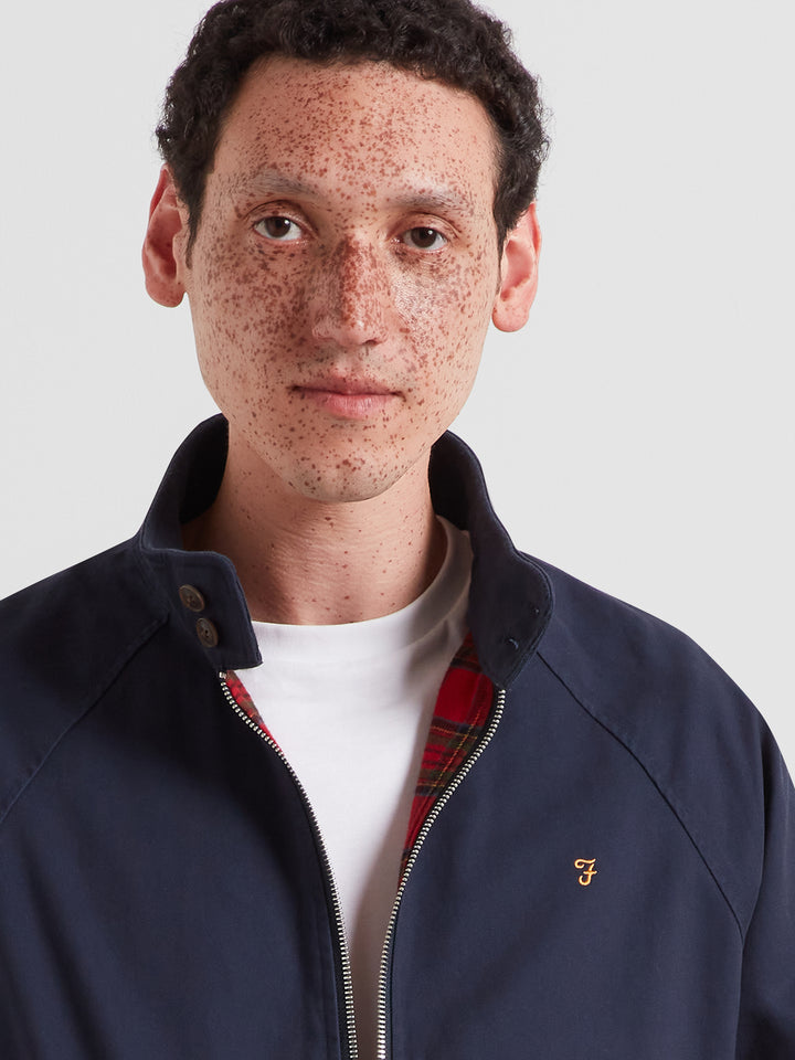 Navy Harrington jacket close-up with full zip, stand collar, small chest logo